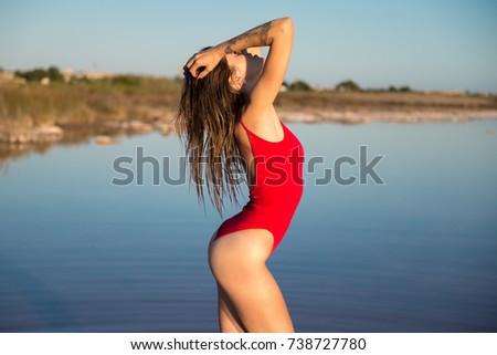 Young girl in red swimsuit at the beach