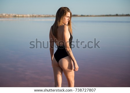Young girl in black swimsuit at the beach