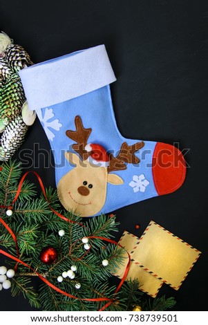 
Christmas sock on a dark background with winter decorations
