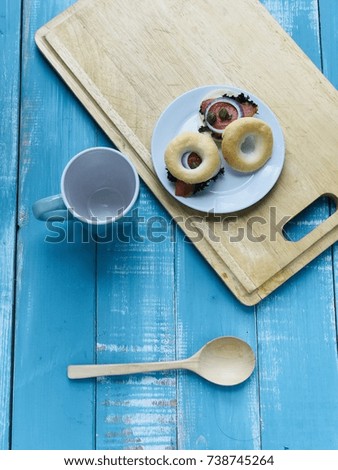 Wooden Blue background with sandwich, spoon and coffee cup 