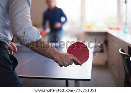 group of young startup business people playing ping pong tennis at modern creative office Royalty-Free Stock Photo #738751051