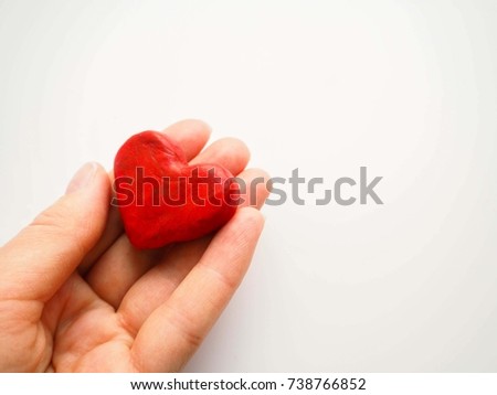 Heart in female hand. Selective focus