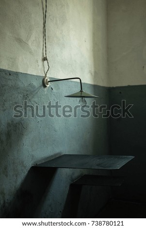 Lamp, table and chair in jail cabin