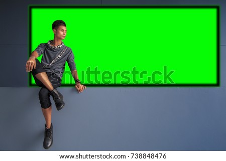 Man watching on broad Green Screen
