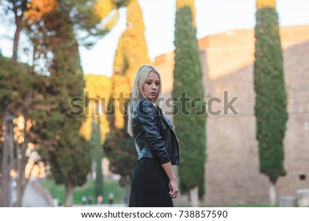young blonde in a black Vatican dress in Italy