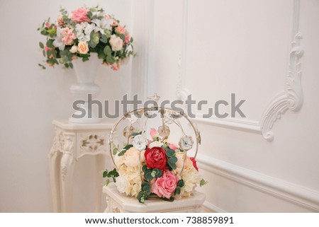 Artificial flowers. Vase with a flower arrangement in an expensive interior.