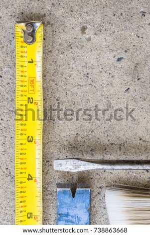 Various tools laid out on concrete background
