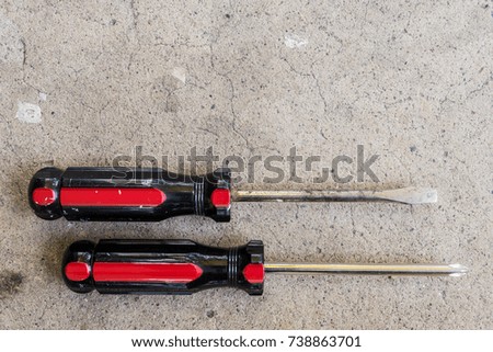Various tools laid out on concrete background