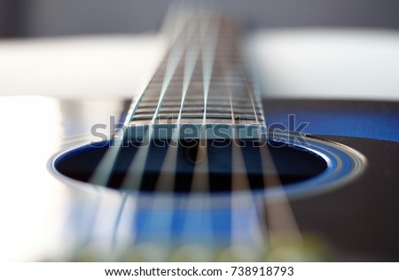 Acoustic Guitar with very shallow depth of field, focus on strings.