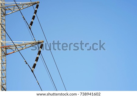   High voltage electric poles on blue sky background                             