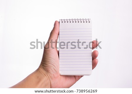 Hand hold white notebook.