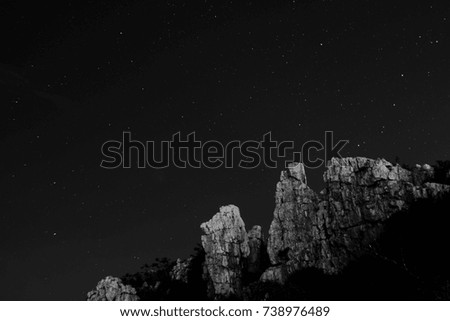 Night stars sky long exposure at Khao Sam Muk mountains ,Thailand on black and white landscape 