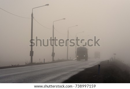 the car on the road in the fog