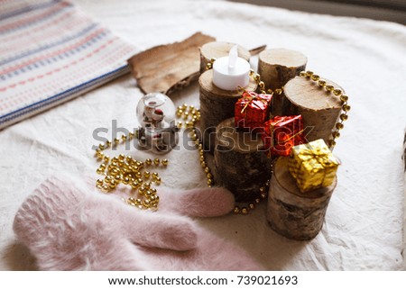 New Year composition from toys, wood, mittens, beads and postcards