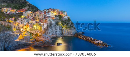 Panorama view of Manarola village one of Cinque Terre at night in La Spezia, Italy. Royalty-Free Stock Photo #739054006