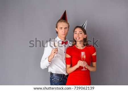 Young couple studio isolated on grey wall concept