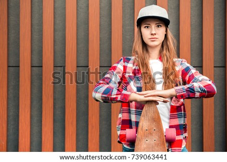 Young woman with skateboard outdoors active lifestyle