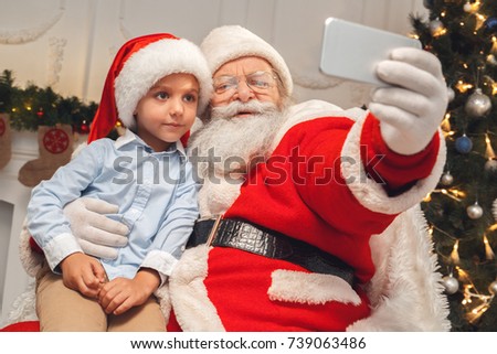 Santa Claus with kids indoors christmas celebration concept