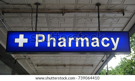 Unspecified universal Pharmacy neon sign above the entrance to the chemist drug store