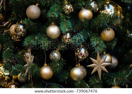 Green New Year tree decorated with toys and balls. Christmas background