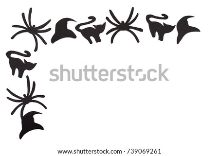 Silhouettes of black cats and spiders and hats carved out of black paper are isolated on white for Halloween festival. Halloween concept