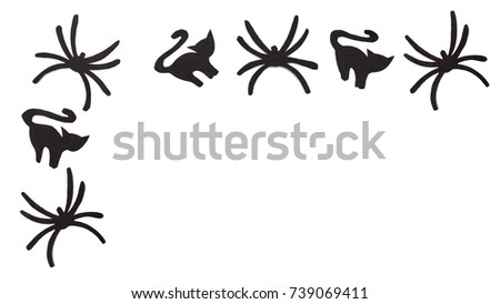 Silhouettes of black cats and spiders carved out of black paper are isolated on white for Halloween festival. Halloween concept