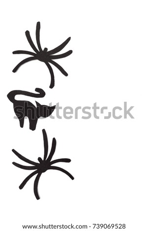 Silhouettes of black cats and spiders carved out of black paper are isolated on white for Halloween festival. Halloween concept