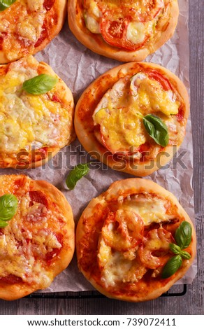 Homemade mini pizzas with different stuffing on wire rack