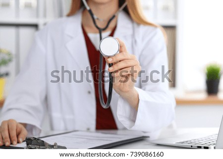 Unknown female doctor with a stethoscope in the hands. Physician is redy to exemine a patient
