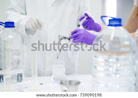 Close up of two scientists checking the quality of water in the laboratory.