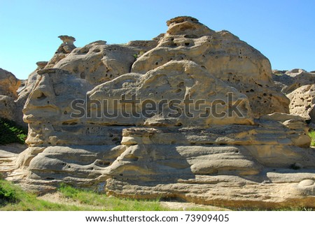 Summer view of hoodoos and sandstone cliff while hiking in writing on stone provincial park. The park is located in milk river valley, south of alberta, canada.