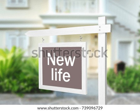 Signboard with text NEW LIFE in front of house