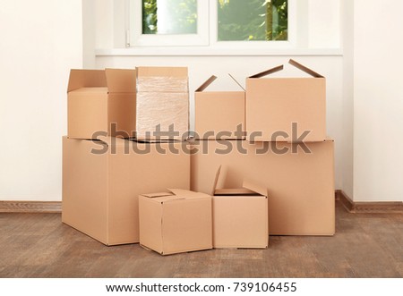 Move house concept. Carton boxes on floor in empty room
