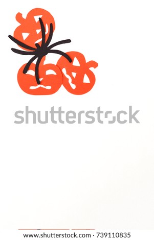 Silhouettes of orange pumpkins and black spider carved out of black paper are isolated on white for Halloween festival. Halloween concept
