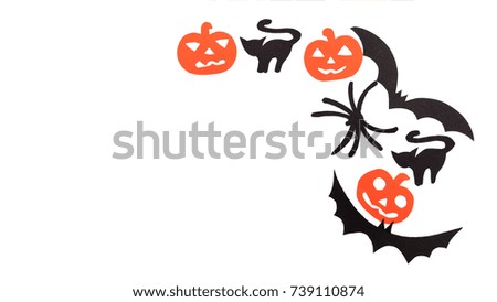 Silhouettes of black volatile bats, cats, orange pumpkins, cats and spider carved out of black paper are isolated on white for Halloween festival. Halloween concept