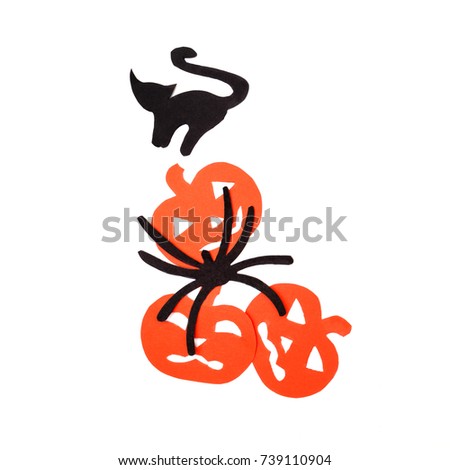 Silhouettes of orange pumpkins black cat and spider carved out of black paper are isolated on white for Halloween festival. Halloween concept