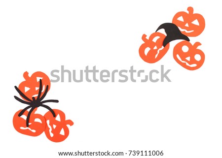 Silhouettes of orange pumpkins, black hat and spider carved out of black paper are isolated on white for Halloween festival. Halloween concept