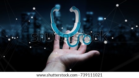 Businessman on blurred background holding and touching medical icon 