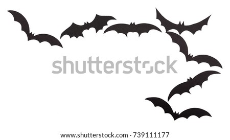 Silhouettes of volatile bats carved out of black paper are isolated on white for Halloween festival