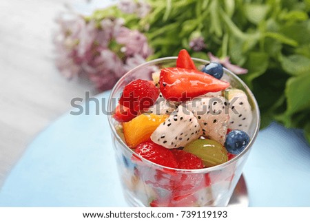 Glass with delicious fruit salad, closeup
