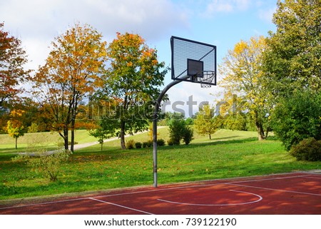A basketball hoop in a park on a sunny autumn day.City park