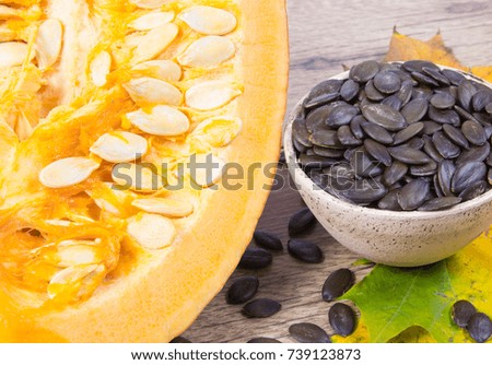 Pumpkin seeds on a wooden background. Close Up.