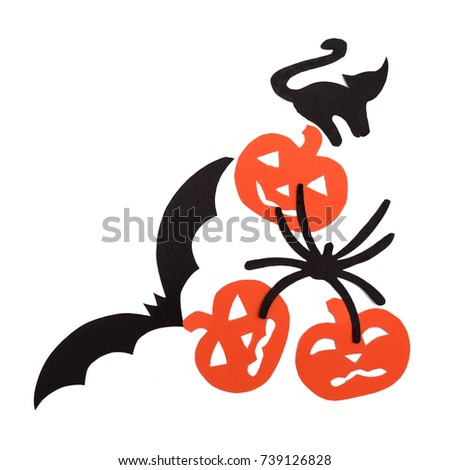 Silhouettes of orange pumpkins black cat, bat and spider carved out of black paper are isolated on white for Halloween festival. Halloween concept