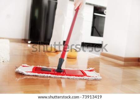 House cleaning -Mopping hardwood floor Royalty-Free Stock Photo #73913419