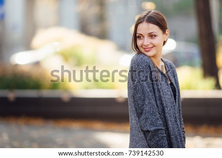 Girl stand on the street and smile to camera