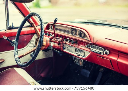 Faded interior of a classic american car from the 1960's. Royalty-Free Stock Photo #739156480