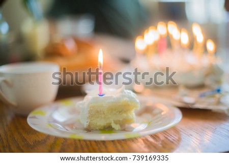 Festive table with cake and roses. A cake with candles for a birthday. Lemon cake.
