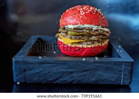Homemade hamburger with red bun