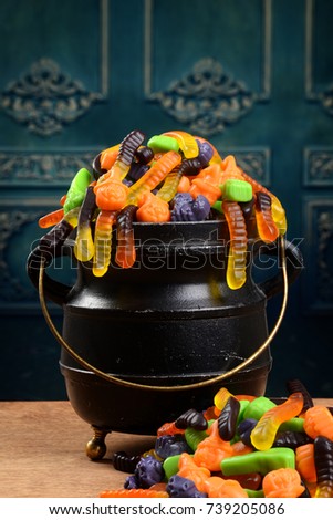 closeup gummy halloween candy in cauldron