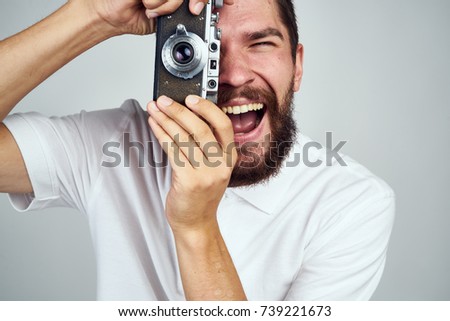 joyful man taking pictures at the camera                               
